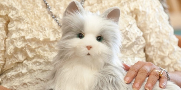 The Hasbro robot pet cat on someone's lap.