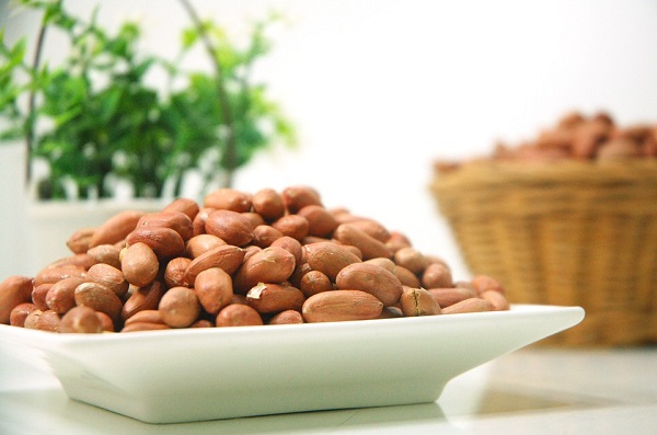 peanuts in white bowl on table