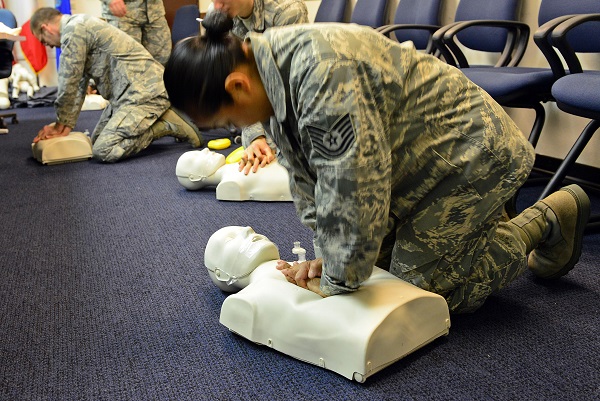 Woman practicing CPR on a mannequin
